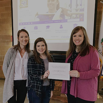 Foundation staff and student holding award