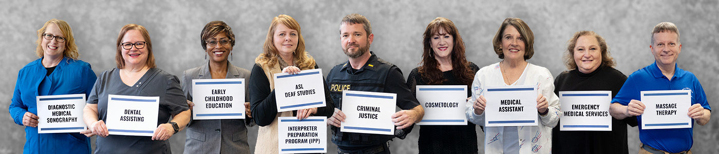 Instructors holding signs for programs within Allied Health and Public Service