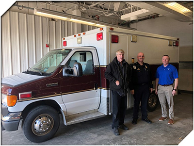 Bruce Davey(Fleet Manager at JC Ambulance), Kenton Schafer(Director at JC Ambulance), and Scott Wernsman standing next to ambulance