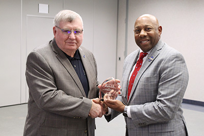 Executive Director of the Illinois Community College Trustees Associaton Jim Reed presents JALC Trustee Jacob “Jake” Rendleman with the Linden A. Warfel Trustee Education Award