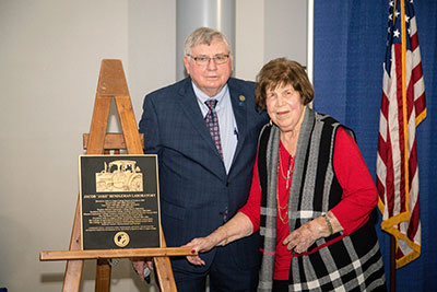 Carolyn Rendleman with husband Jake Rendleman and plaque for Jacob "Jake" Rendleman Laboratory