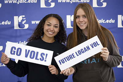 Two students holding signs that say GO VOLS! and FUTURE LOGAN VOL