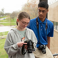 Students Abigail Cullum and Enan Chediak review photo on camera screen
