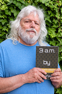 Ken Gilbert holding his book