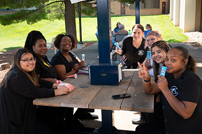 Students at table with popsicles