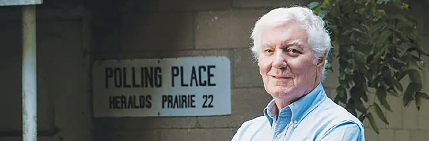 Glenn Poshard standing near polling place sign