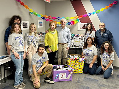 Social Workers for Change club members and Jo and Glen Poshard with donated socks