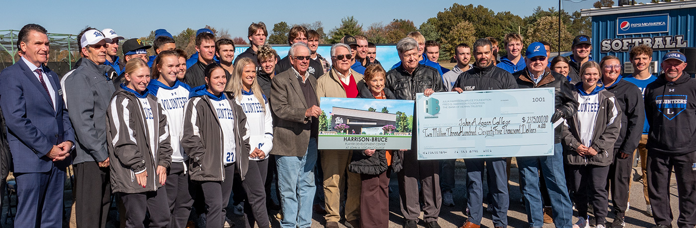 Group at the Harrison-Bruce Foundation check presentation holding a mock-up of the Harrison-Bruce Player Development Center and the check.