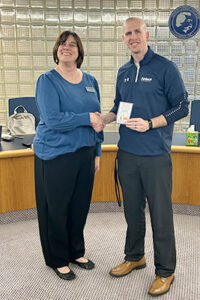 Cathrine Hoekstra presents Bradley Griffith with award for perfect attendance at Shared Governance meetings.