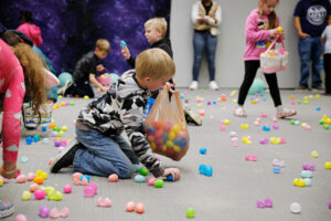 Children pick up eggs at the Dr. Patchett Eggstravaganza Celebrating Neuro-Diversity event.