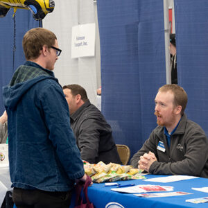A representative from Kroger speaks to an attendee at the JALC Annual Job Fair.