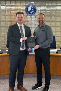 Student Trustee Magnus Noble is presented with a plaque from Vice-Chair Aaron Smith.