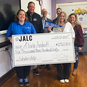 Alivia Androff is presented with a scholarship check from JALC.