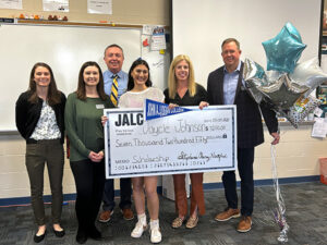 Jaycie Johnson is presented with a scholarship check from JALC.