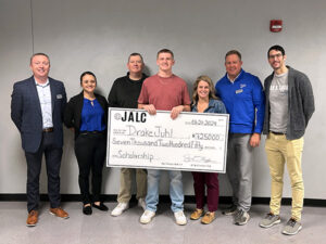 Drake Juhl is presented with a scholarship check from JALC.
