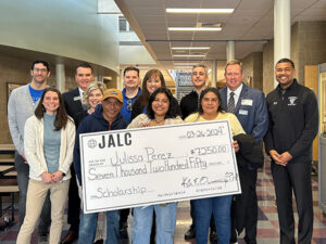 Julissa Perez is presented with a scholarship check from JALC.