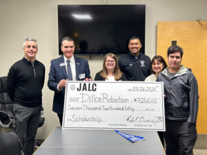 Dillon Robertson is presented with a scholarship check from JALC.