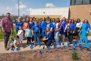 Participants and blue pinwheels at the Poshard Child Abuse Prevention Month Kickoff