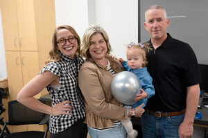 Christy Stewart with daughter, granddaughter, and husband at her retirement party.