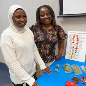 Toyin Fox with guest at spice table for World Music and Food Day