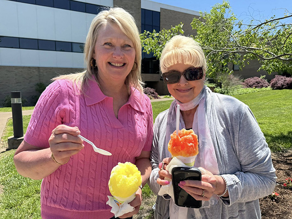 Senior Executive Assistant Carmen Cutsinger and Executive Assistant II Pixie Vaughn hold snow cones at the JALC Employee Appreciation Luncheon.