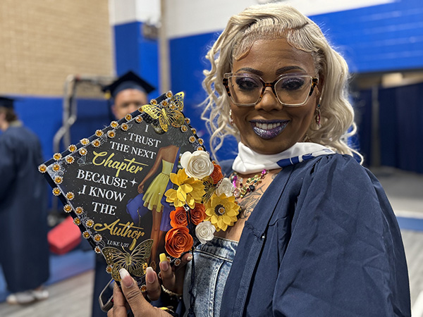 Student with decorated cap at JALC graduation.