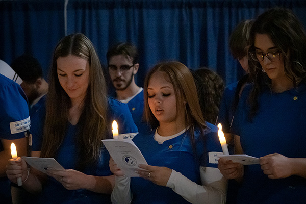 LPN students with candles at graduation.