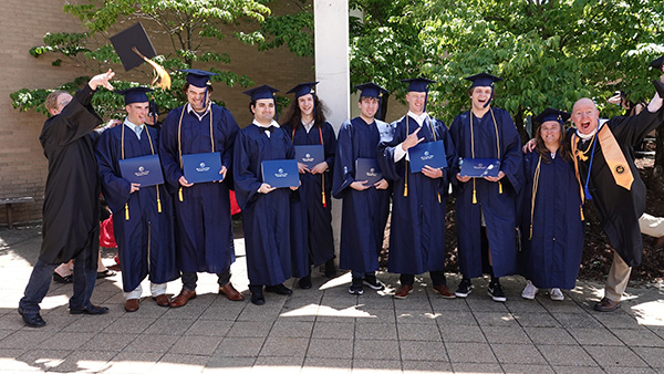 Group picture of Associate Professor of Electronics Rob Craig with his student graduates.