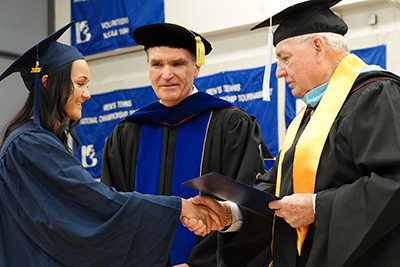 Livvia Deaton, a Marion High School Graduate, receives her degree from JALC President Dr. Kirk Overstreet and Board Vice Chair Jake Rendleman.
