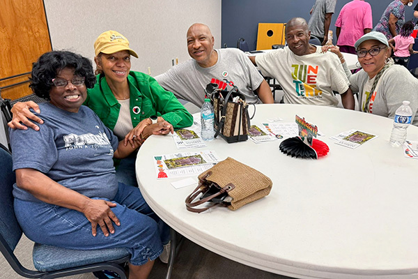 Group at table at JALC's Juneteenth event.