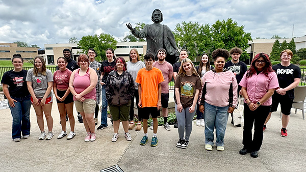 Summer Bridge Program students next to John A. Logan statue on JALC campus.