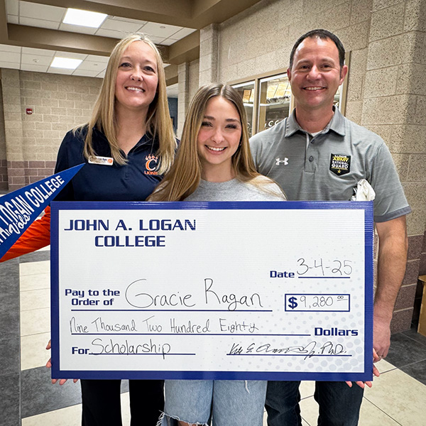 Gracie Ragan and family with scholarship check for JALC.