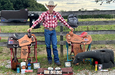 Leo Loucks stands with his awards.