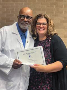 Frank Henson receives certificate from Crystal Young.