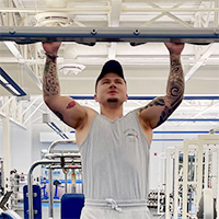 Jeff Lewis doing a pull up at Logan Fitness.
