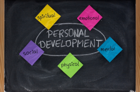 Colorful sticky notes on a chalkboard. The chalkboard reads PERSONAL DEVELOPMENT and is circled. The sticky notes read spiritual, emotional, social, physical, and mental.