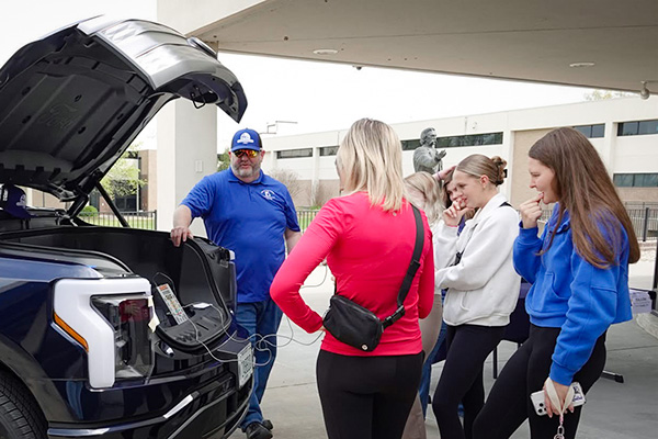 JALC Professor of Auto Collision/Auto Services, Joseph Roach, shows students electric pickup truck.
