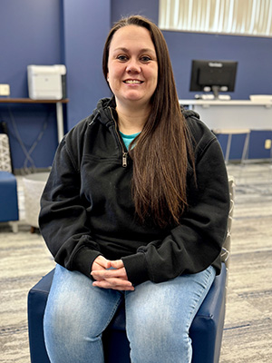 Whitney York sitting in a chair.