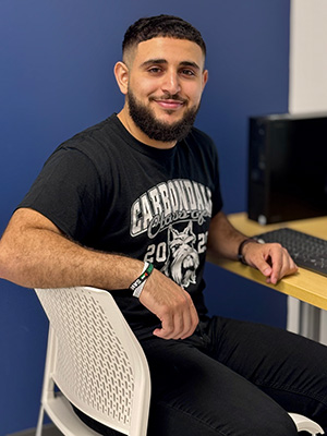 JALC student Omar Naser sitting in chair.