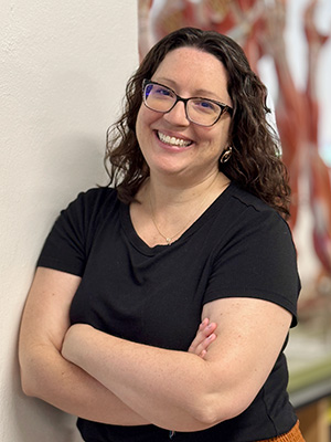 Rebecca Corbit leaning against wall.
