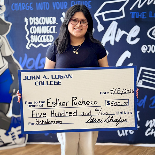 Student Esther Pacheco with scholarship check.