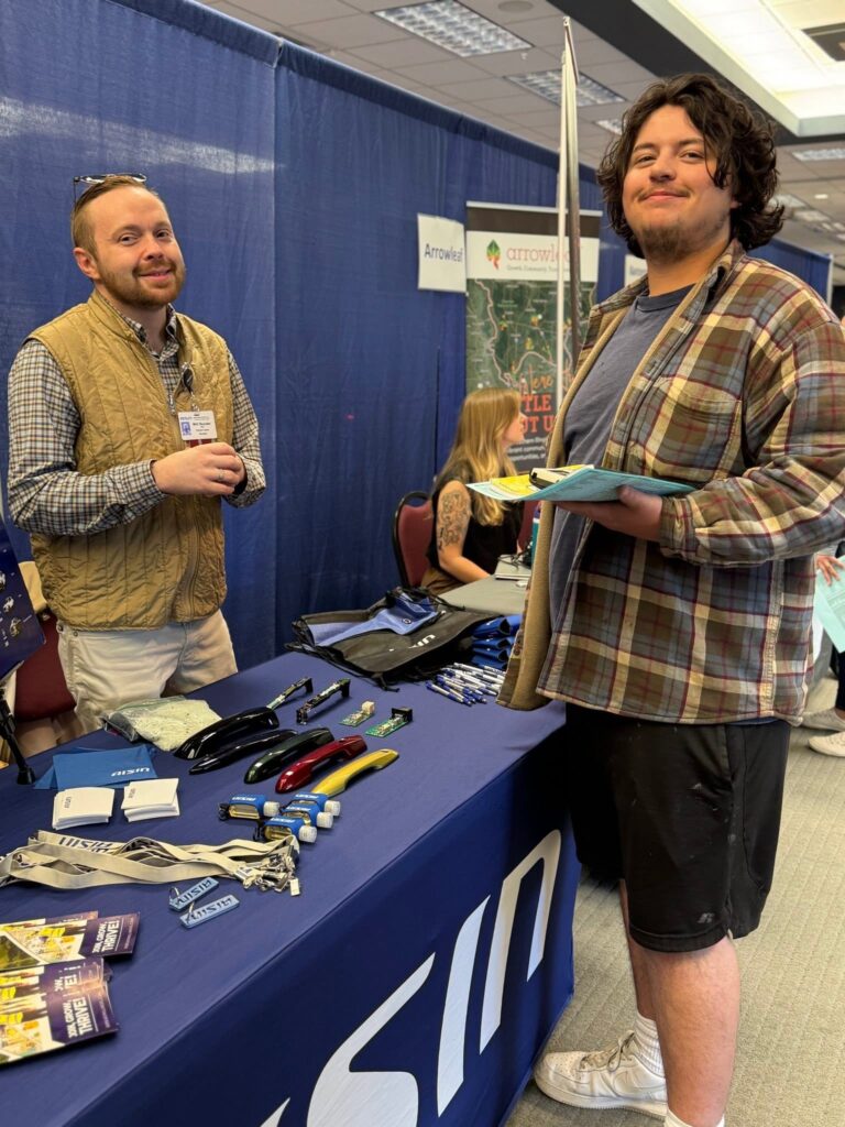 AISIN speaking with a student at the annual Career Fair.